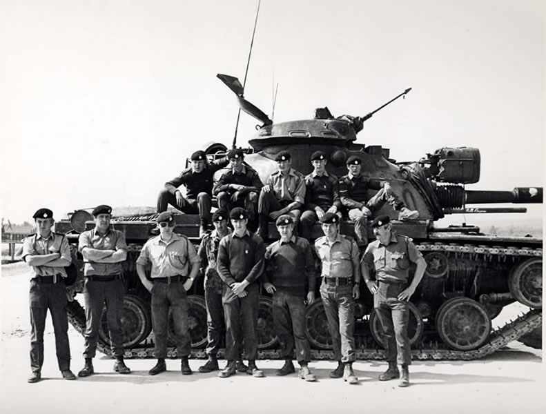 The team posing in front of an M 48